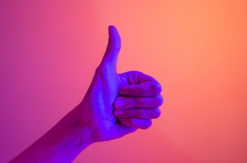 persons hand doing thumbs up