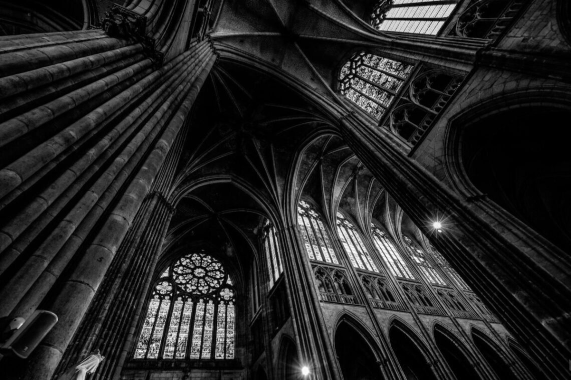 grayscale photography of cathedral ceiling