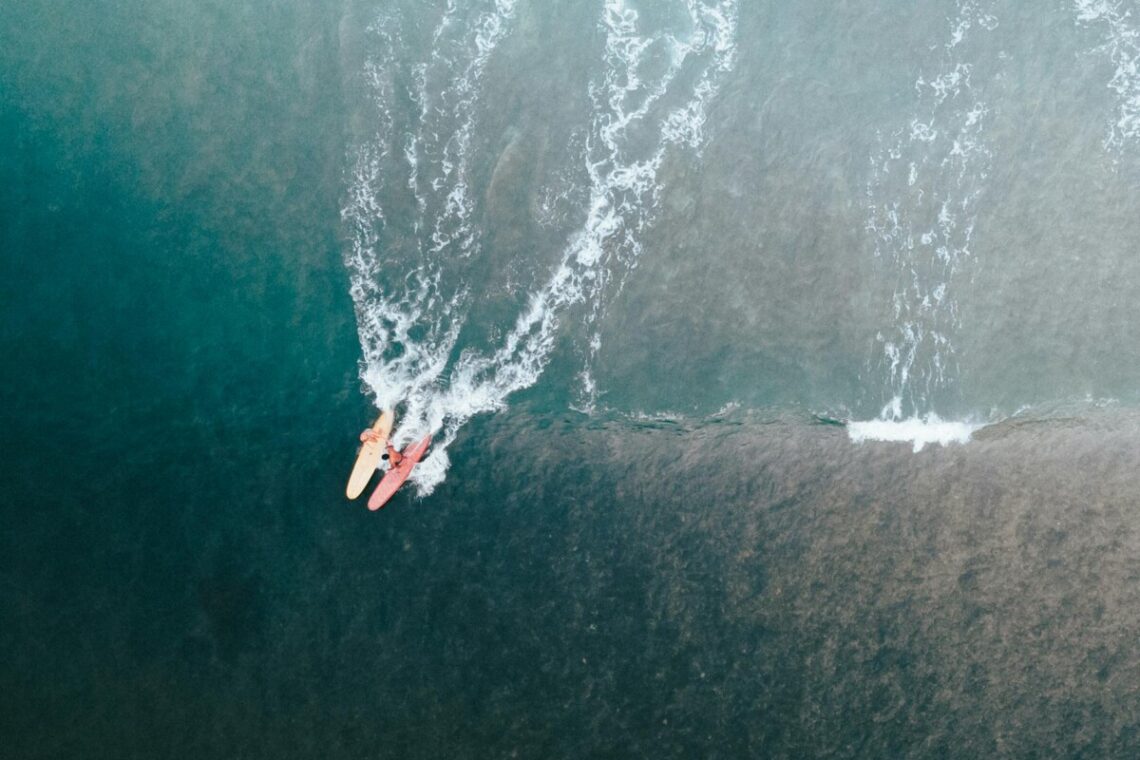 aerial shot of surfers on the sea
