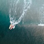 aerial shot of surfers on the sea