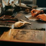 person in black long sleeve shirt holding brown wooden chopping board