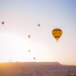 hot air balloons in the sky during sunset