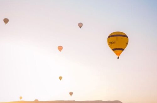 hot air balloons in the sky during sunset